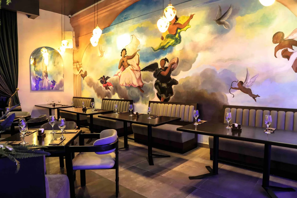 The Paradis Lagos dining room, set beneath its hand-painted mural