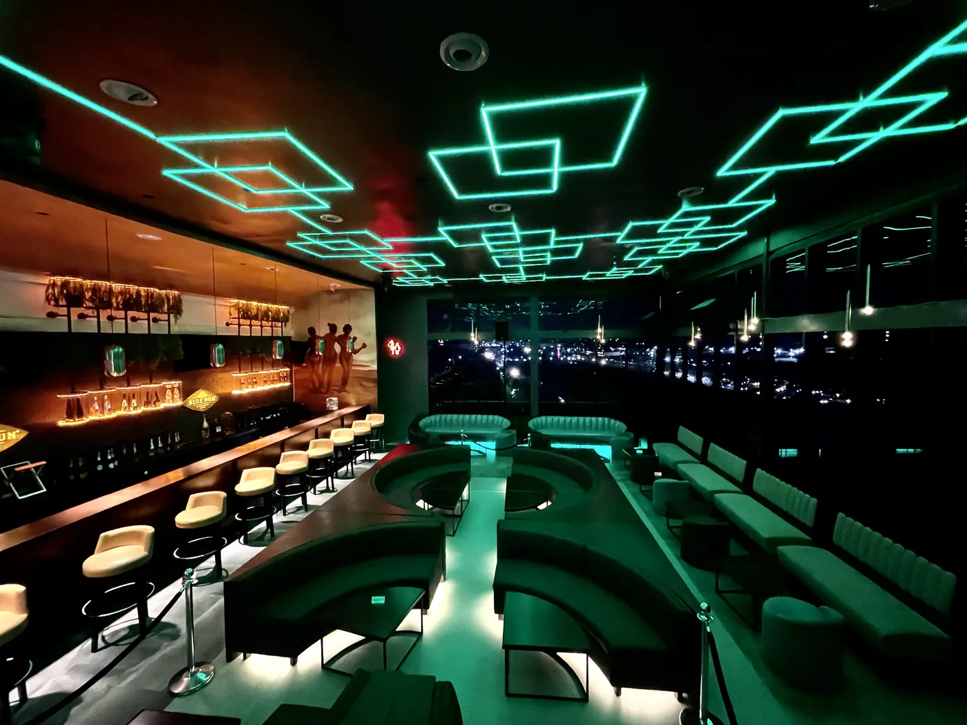 The Paradis Lagos lounge bar under teal neon light