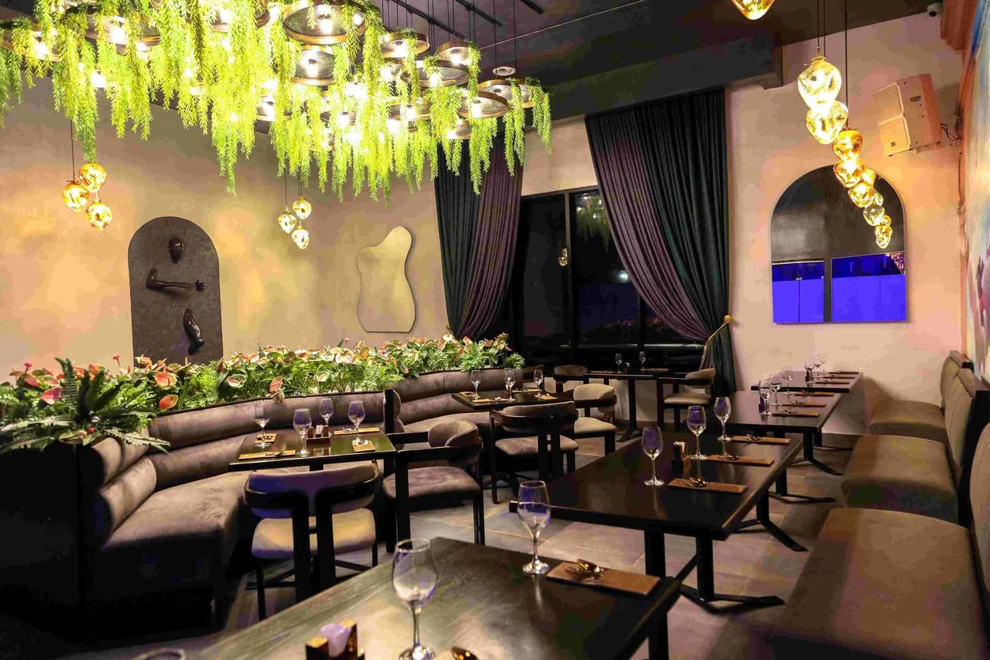 The dining room at Paradis Lagos, framed by hanging greenery
