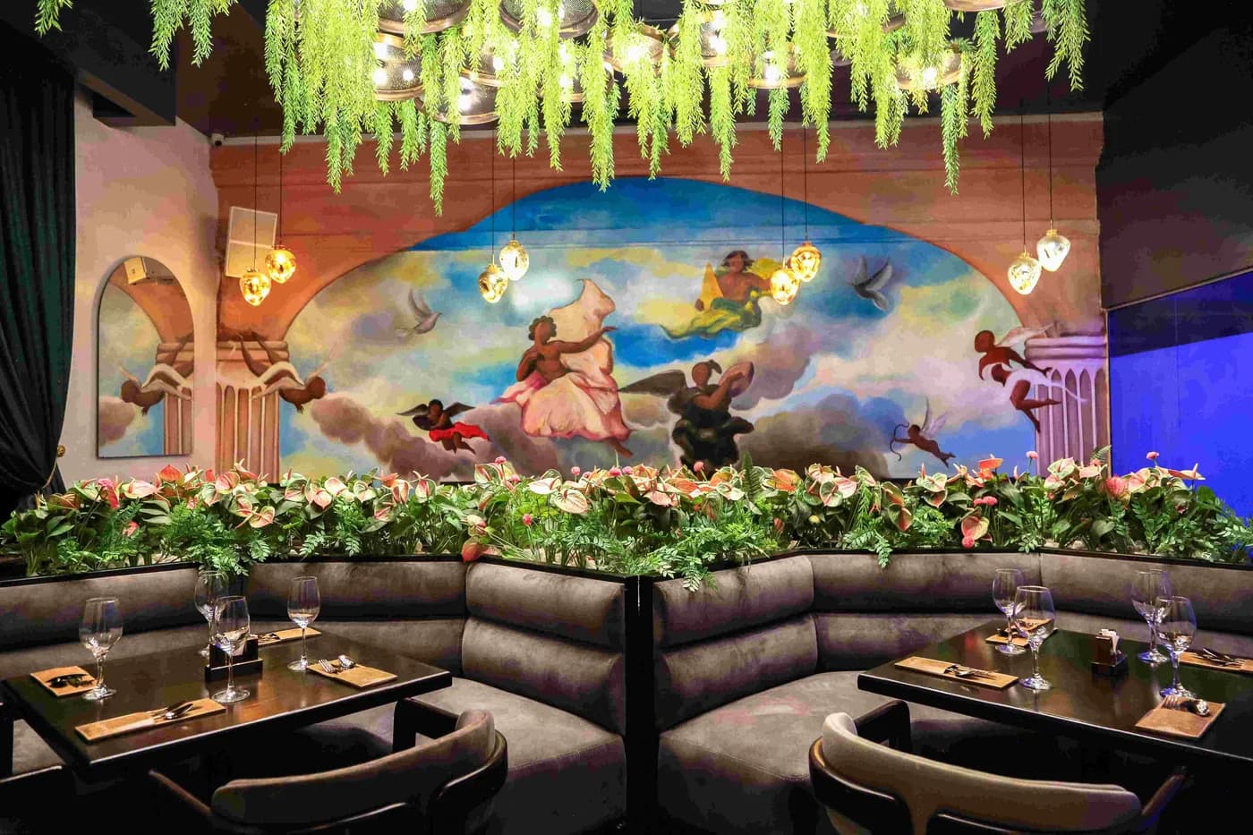 Banquette seating beneath the mural in the Paradis Lagos restaurant