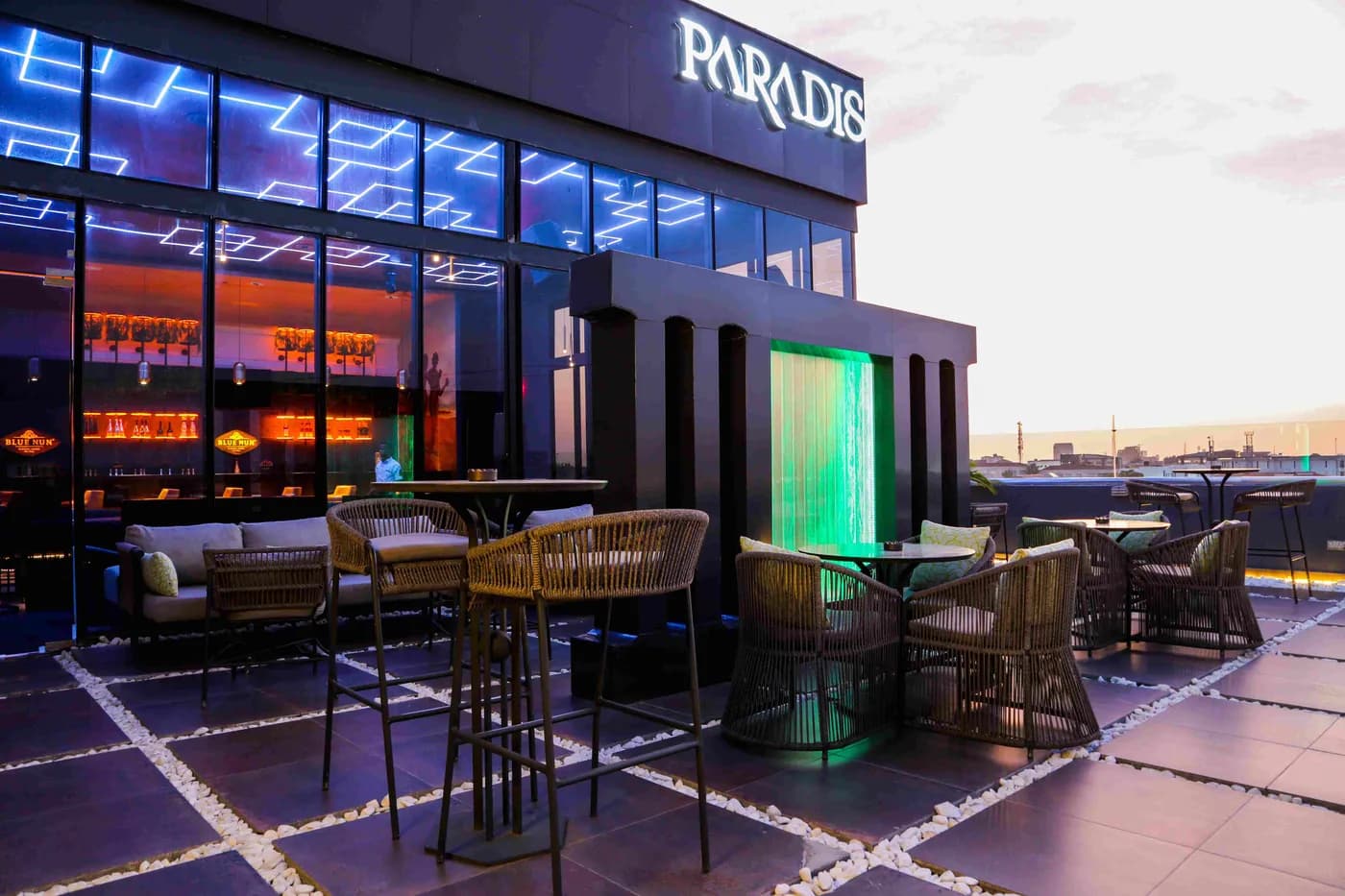 The Paradis Lagos rooftop at night, lit against the Lekki skyline